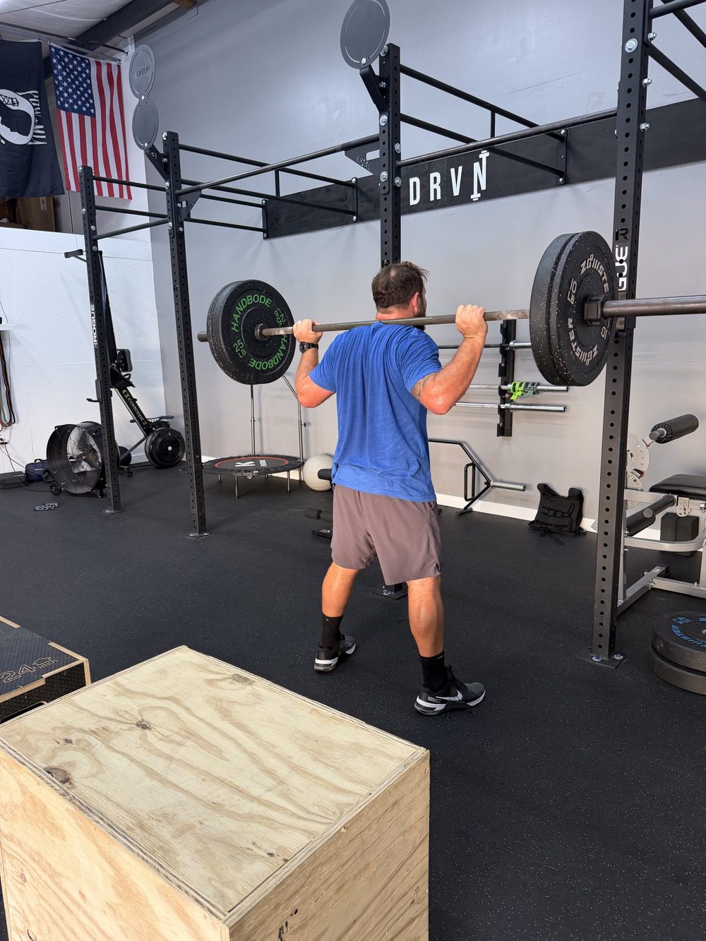 Client back squat during a 1:1 personal training session in Surfside Beach