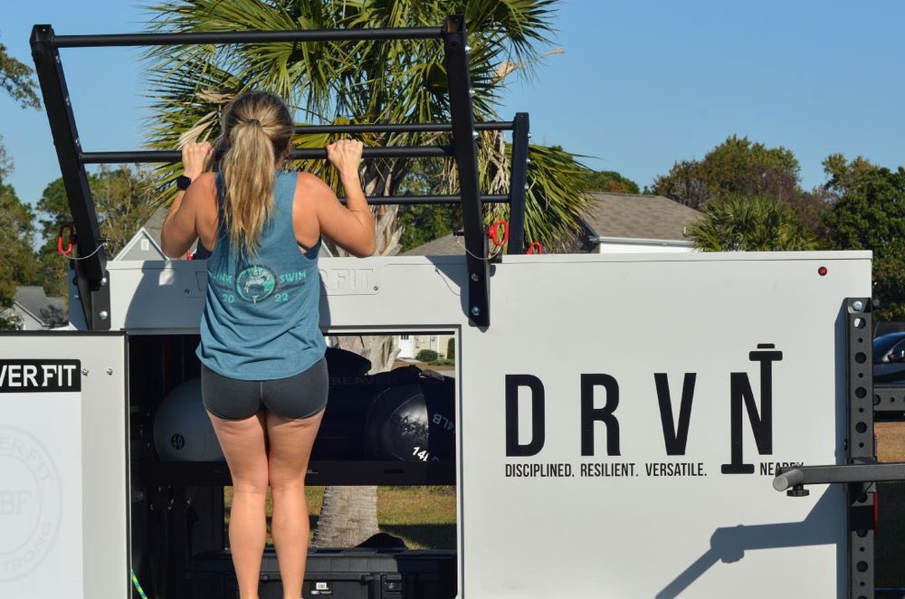 Athlete doing pull-ups on the DRVN mobile training rig