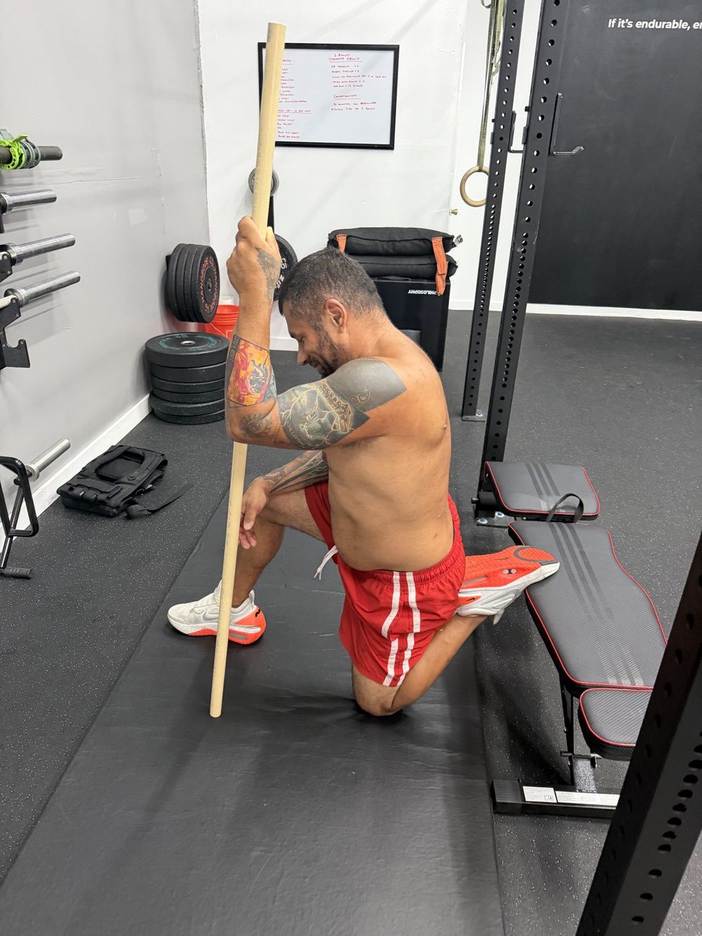 Client doing a kneeling hip mobility stretch at the DRVN gym